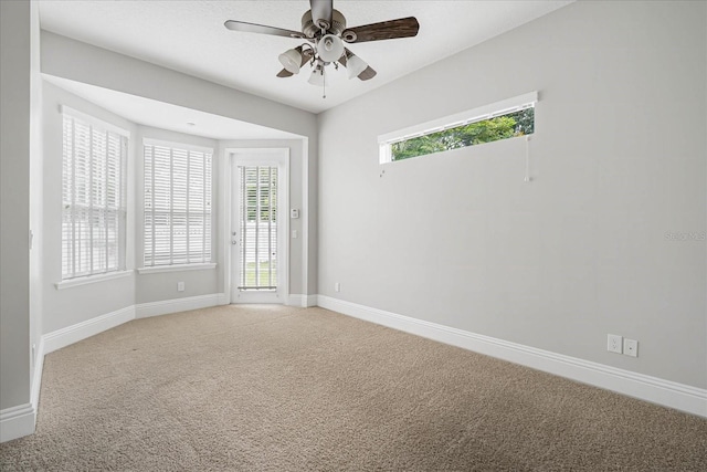 carpeted empty room featuring ceiling fan