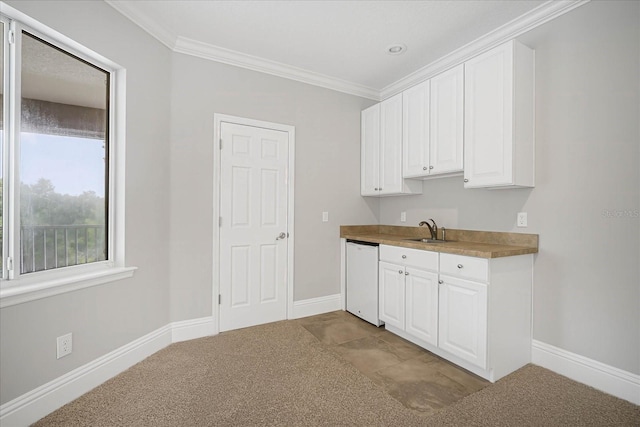 kitchen with ornamental molding, sink, white cabinets, and white dishwasher