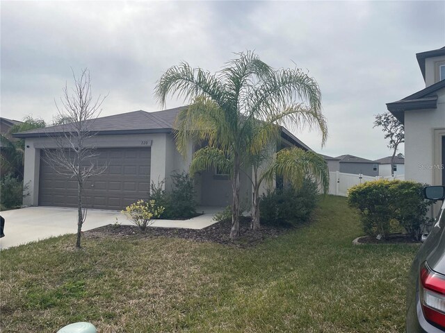 view of side of property featuring a garage and a yard