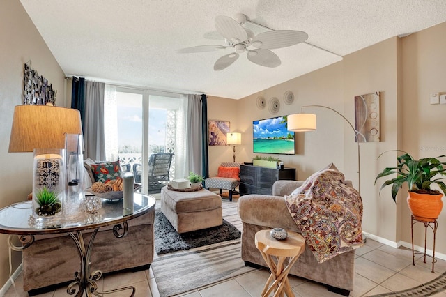 tiled living room featuring ceiling fan and a textured ceiling