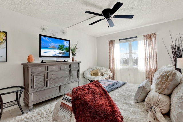 tiled bedroom featuring a textured ceiling and ceiling fan