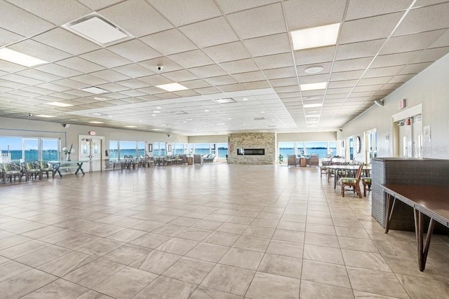 interior space featuring light tile patterned flooring and a paneled ceiling