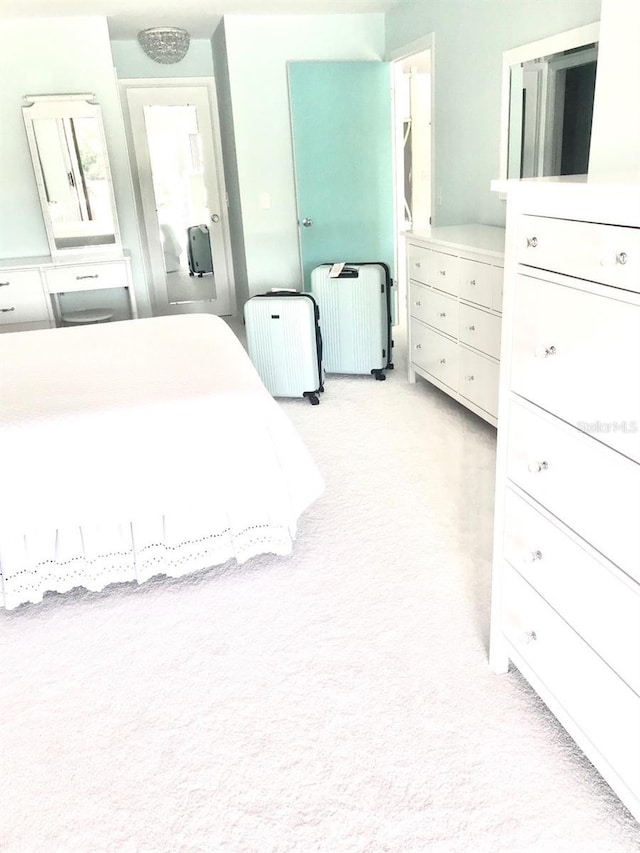 unfurnished bedroom with radiator and light colored carpet