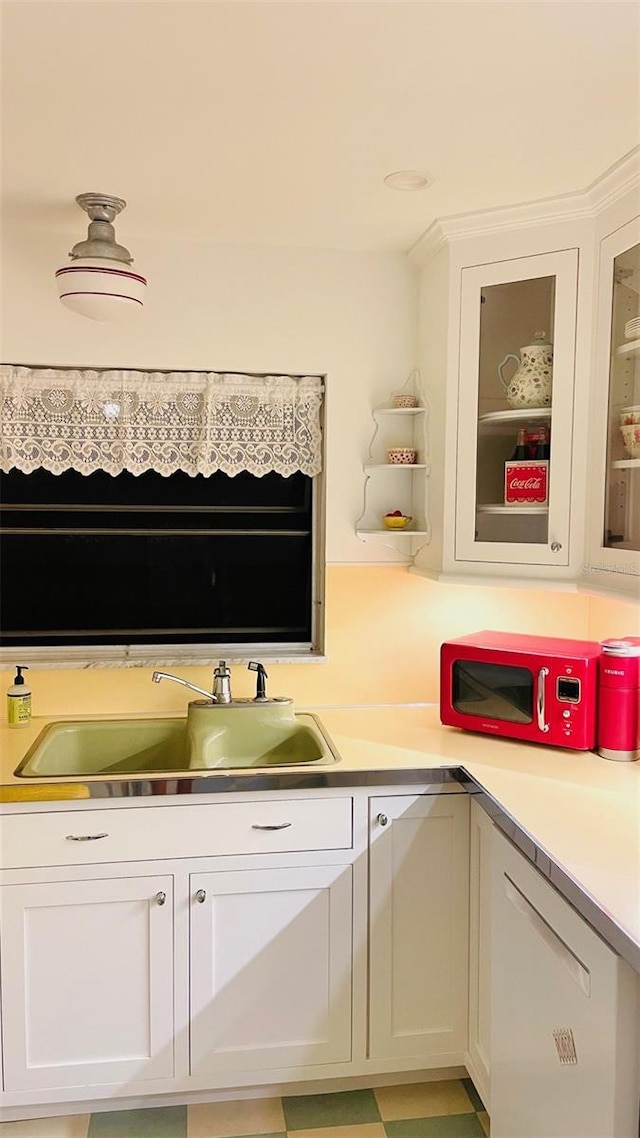 kitchen with white cabinets, sink, and dishwasher