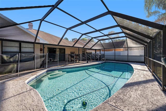 view of pool with a fenced in pool, a lanai, and a patio