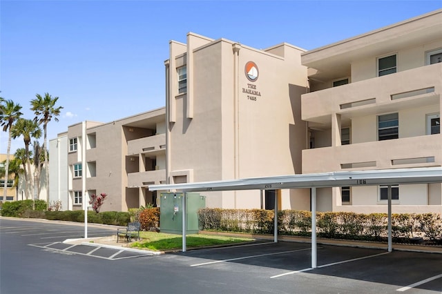 view of property featuring covered parking