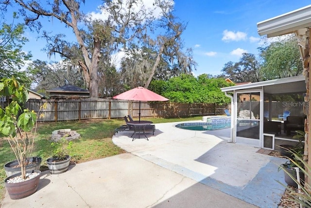 view of patio with a sunroom, a fenced backyard, and a fenced in pool