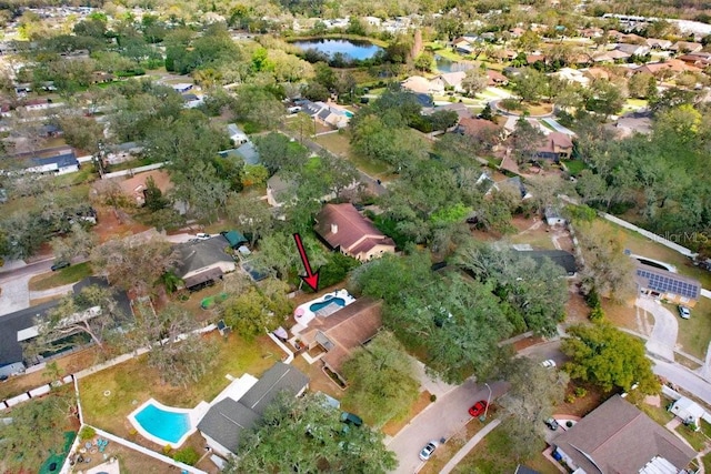 birds eye view of property with a water view and a residential view