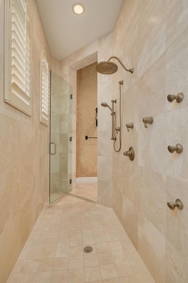 bathroom featuring a shower with shower door