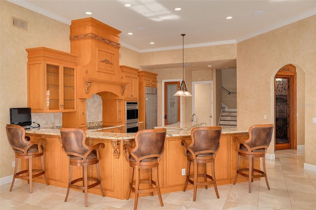 kitchen with pendant lighting, a breakfast bar area, stainless steel appliances, ornamental molding, and kitchen peninsula