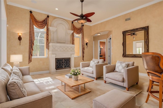 living room featuring ornamental molding and ceiling fan