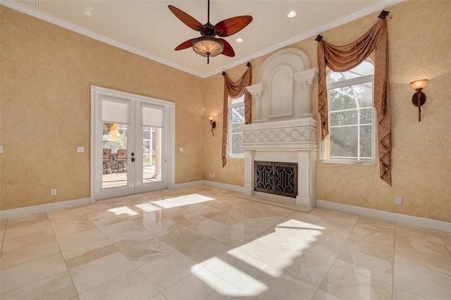 unfurnished living room with crown molding, ceiling fan, a high end fireplace, and french doors