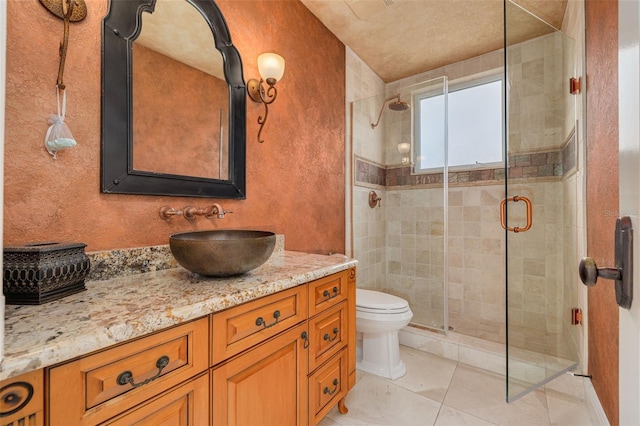 bathroom featuring walk in shower, tile patterned floors, vanity, and toilet