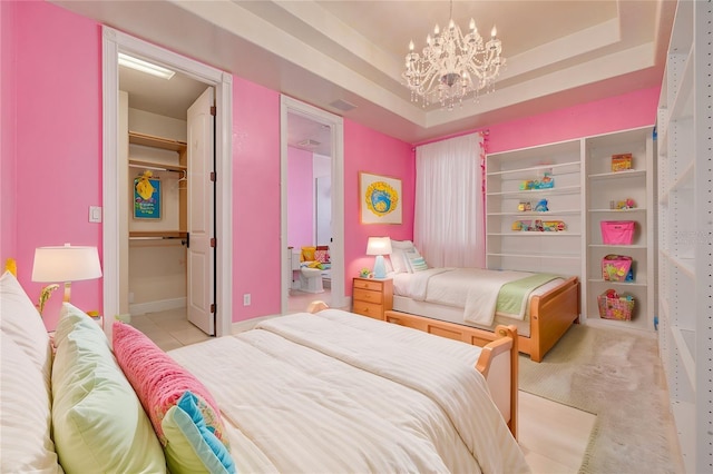 carpeted bedroom with a raised ceiling and a chandelier