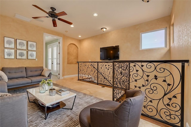 living room with ceiling fan and a wealth of natural light