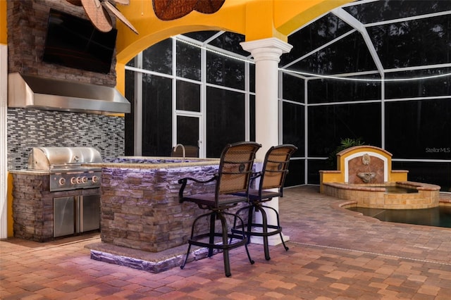 view of patio featuring a grill, area for grilling, an outdoor bar, and ceiling fan