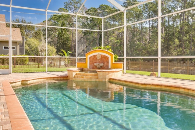 view of pool featuring a hot tub and a lanai