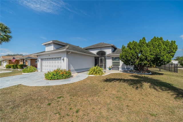 view of front of property featuring a garage, fence, concrete driveway, and a front yard