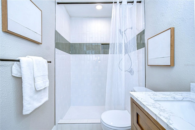 bathroom featuring toilet, vanity, and a shower with curtain