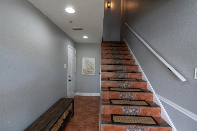 staircase with tile patterned floors