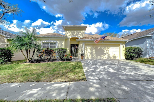 mediterranean / spanish-style house with a garage and a front yard