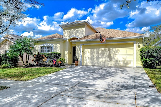 view of front of home featuring a garage and a front lawn