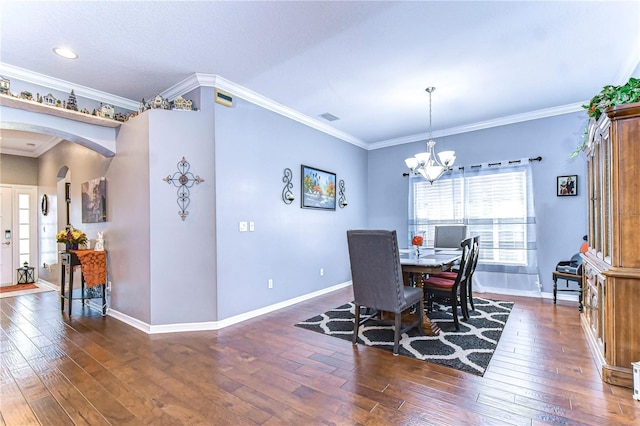 dining room featuring ornamental molding, dark hardwood / wood-style floors, and a notable chandelier