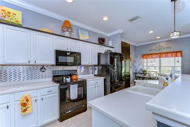 kitchen with white cabinetry, hanging light fixtures, black appliances, and sink