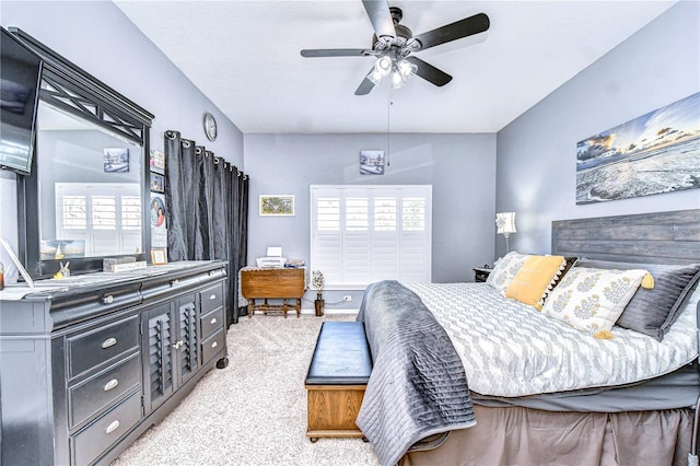 bedroom featuring light colored carpet and ceiling fan