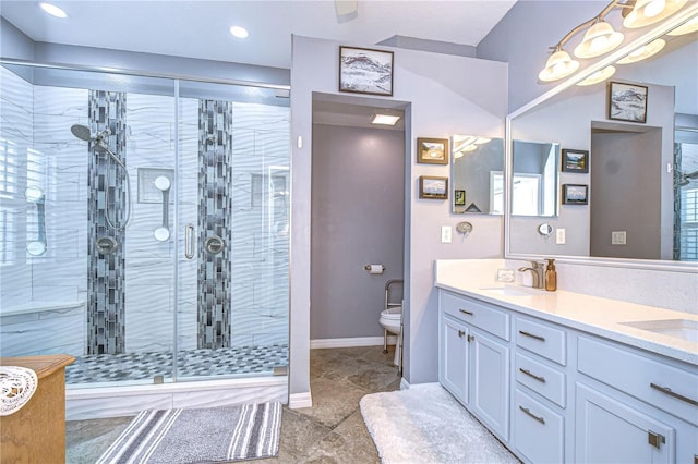 bathroom featuring vanity, an enclosed shower, and toilet