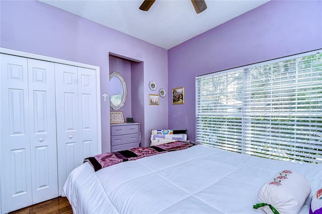 bedroom featuring ceiling fan, hardwood / wood-style floors, a closet, and a textured ceiling