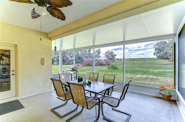 sunroom featuring a wealth of natural light and ceiling fan