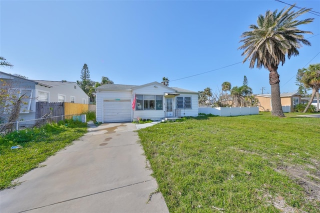 single story home featuring a garage and a front yard