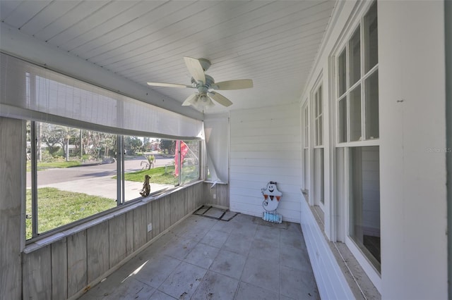 unfurnished sunroom with ceiling fan