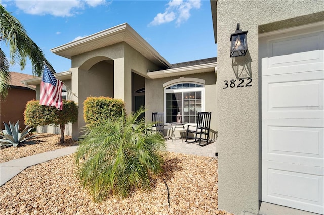 view of exterior entry featuring a garage