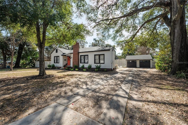 view of front facade featuring a garage and an outdoor structure