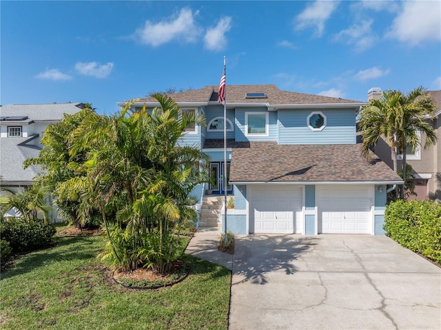 view of front of house featuring a garage and a front lawn