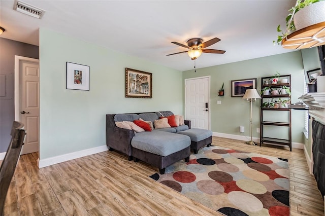 living room featuring ceiling fan and light wood-type flooring