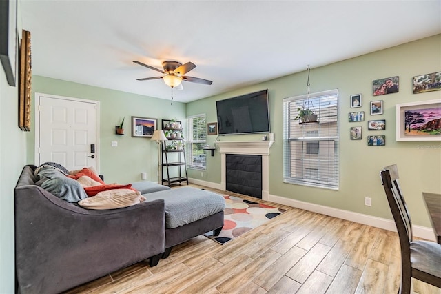 living room with ceiling fan and light hardwood / wood-style floors