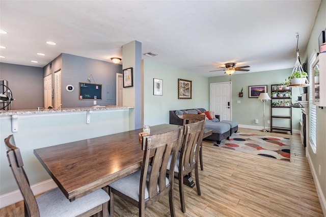 dining room with ceiling fan and light hardwood / wood-style floors