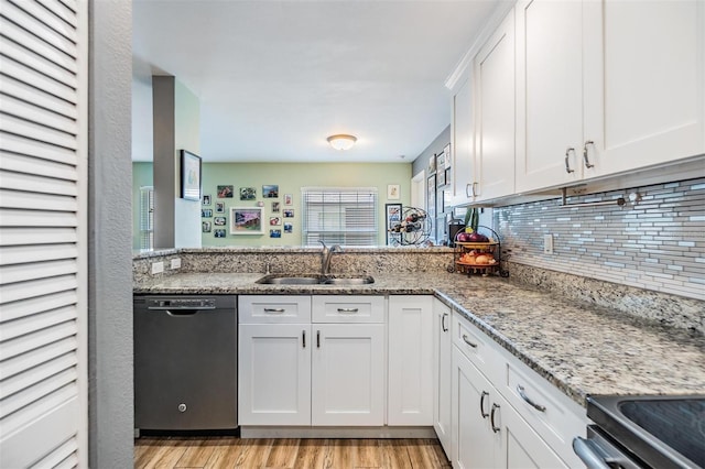 kitchen with white cabinetry, dishwasher, light stone countertops, and sink