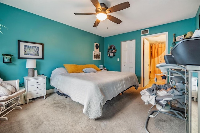 carpeted bedroom featuring a closet and ceiling fan