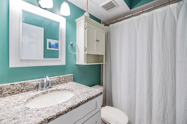 bathroom featuring vanity, toilet, and curtained shower