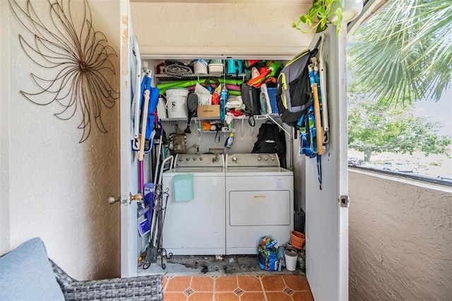 laundry area with separate washer and dryer and tile patterned flooring