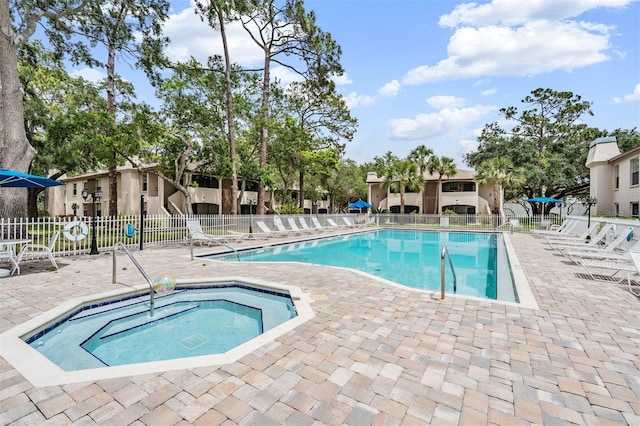 view of pool featuring a patio area and a hot tub