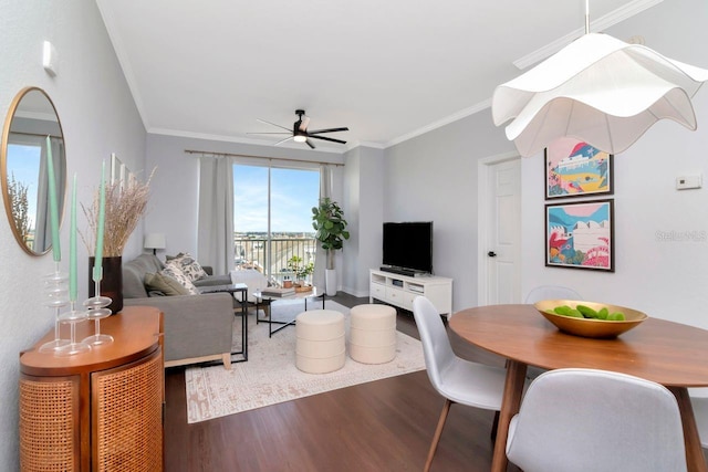 living room featuring ornamental molding, wood finished floors, and a ceiling fan