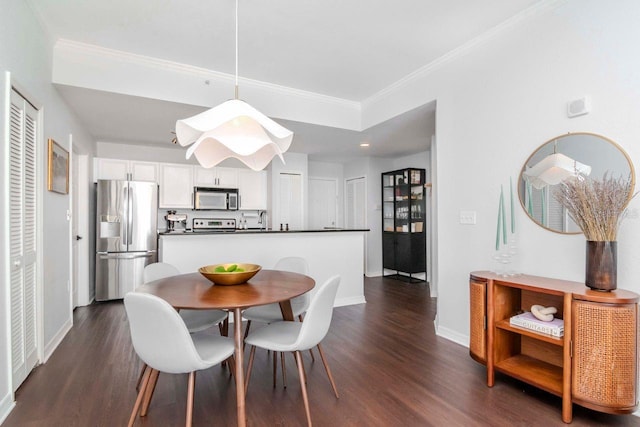 dining space featuring ornamental molding, dark wood finished floors, and baseboards