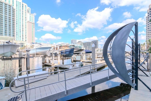 exterior space featuring a boat dock, boat lift, and a city view