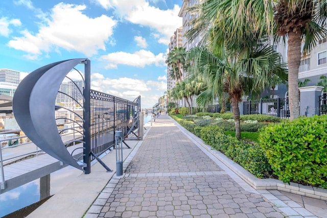 view of home's community featuring fence