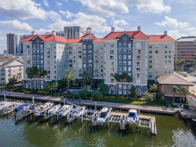 view of building exterior with a water view and boat lift